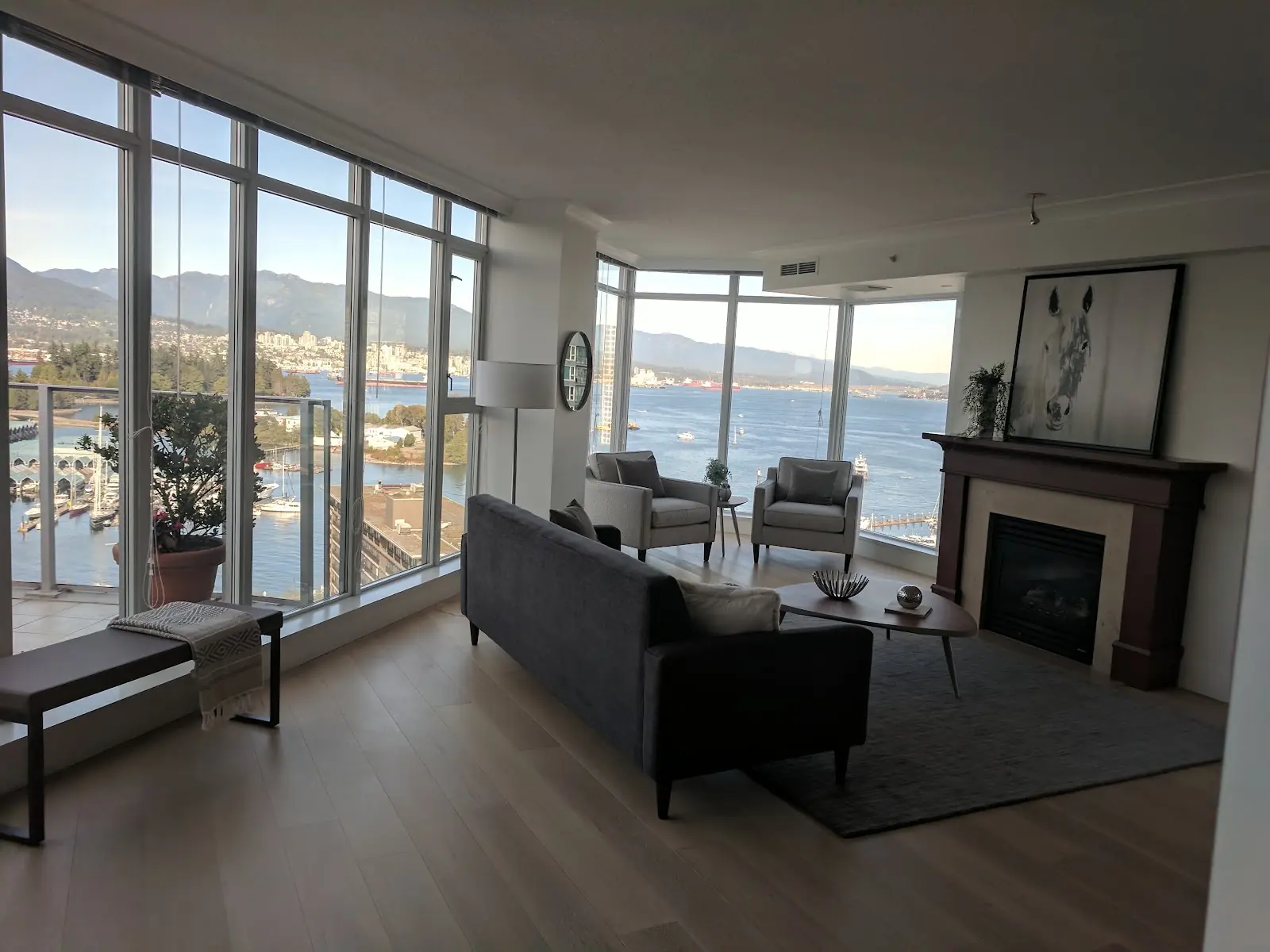 Hardwood in the furnished Bayshore living room beside the waterfront windows
