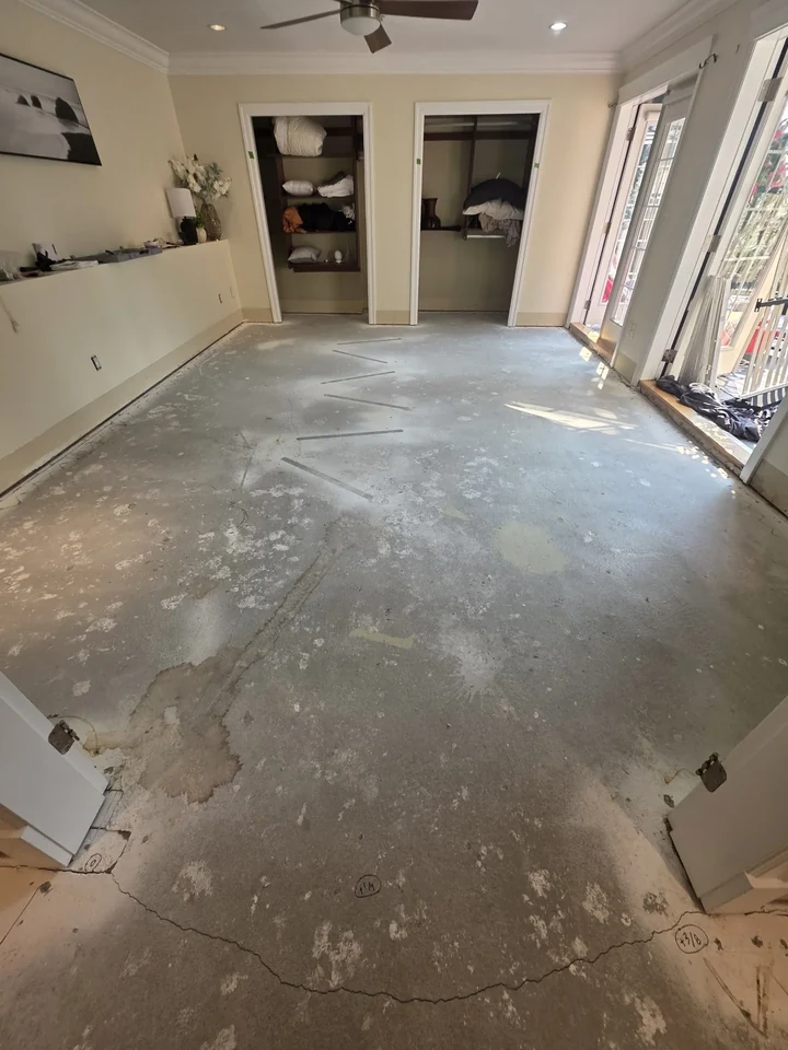 Paint, residue and assessment notes on the exposed concrete in the Westport bedroom before preparation