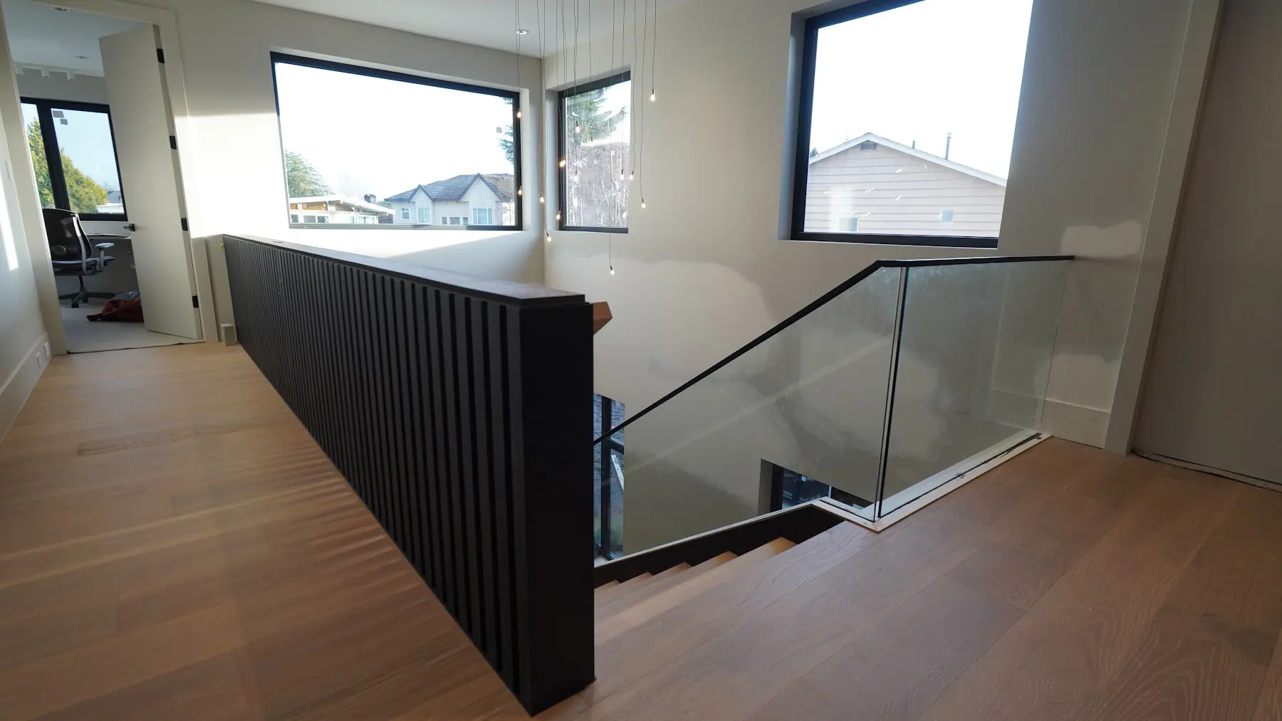 Oak landing at a glass stairwell