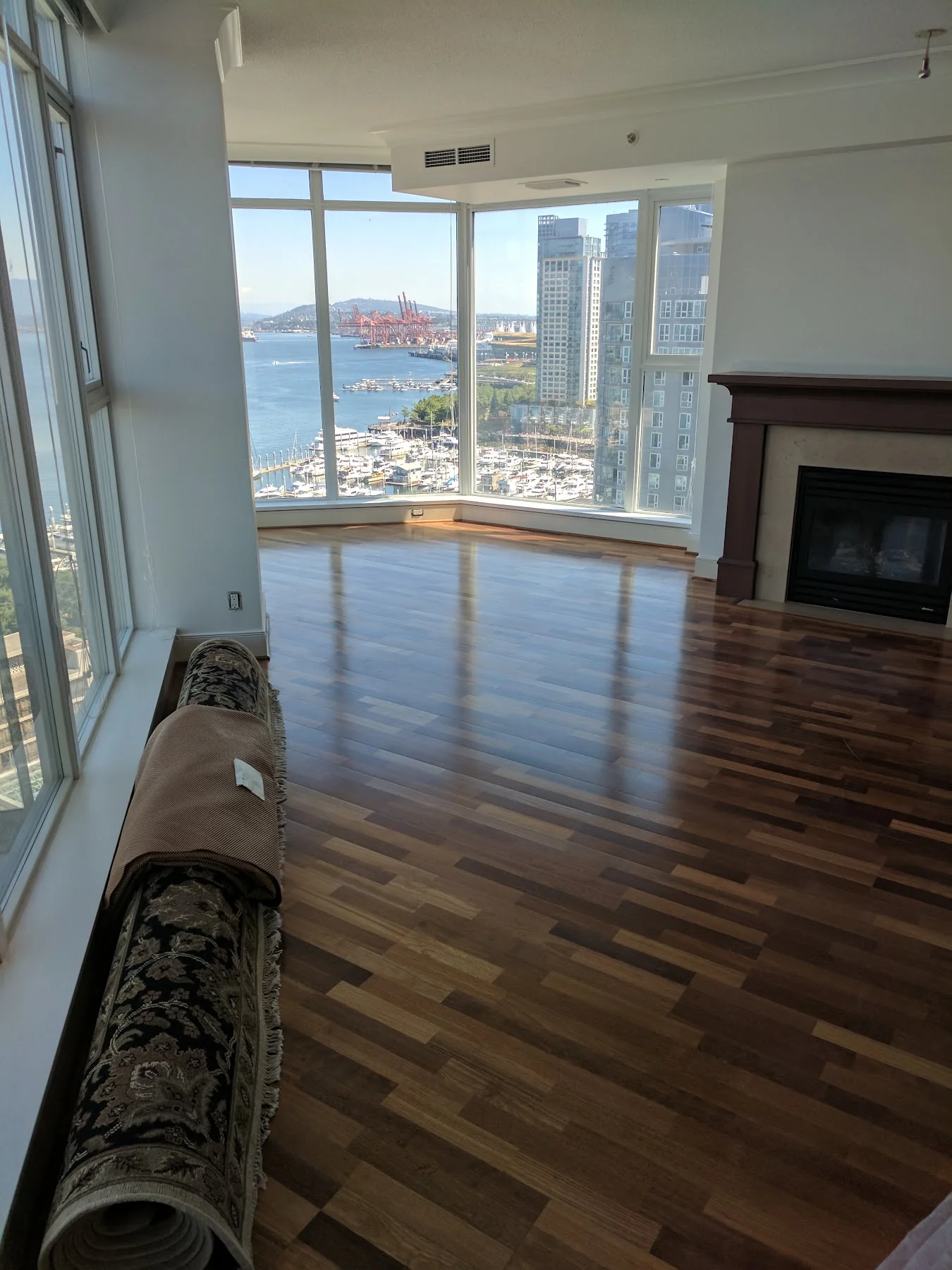 Before renovation: the original darker floor beside the waterfront windows.