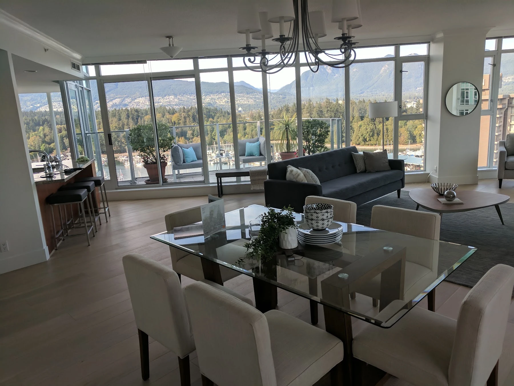 Hardwood through the penthouse dining and living spaces, with marina and mountain views.