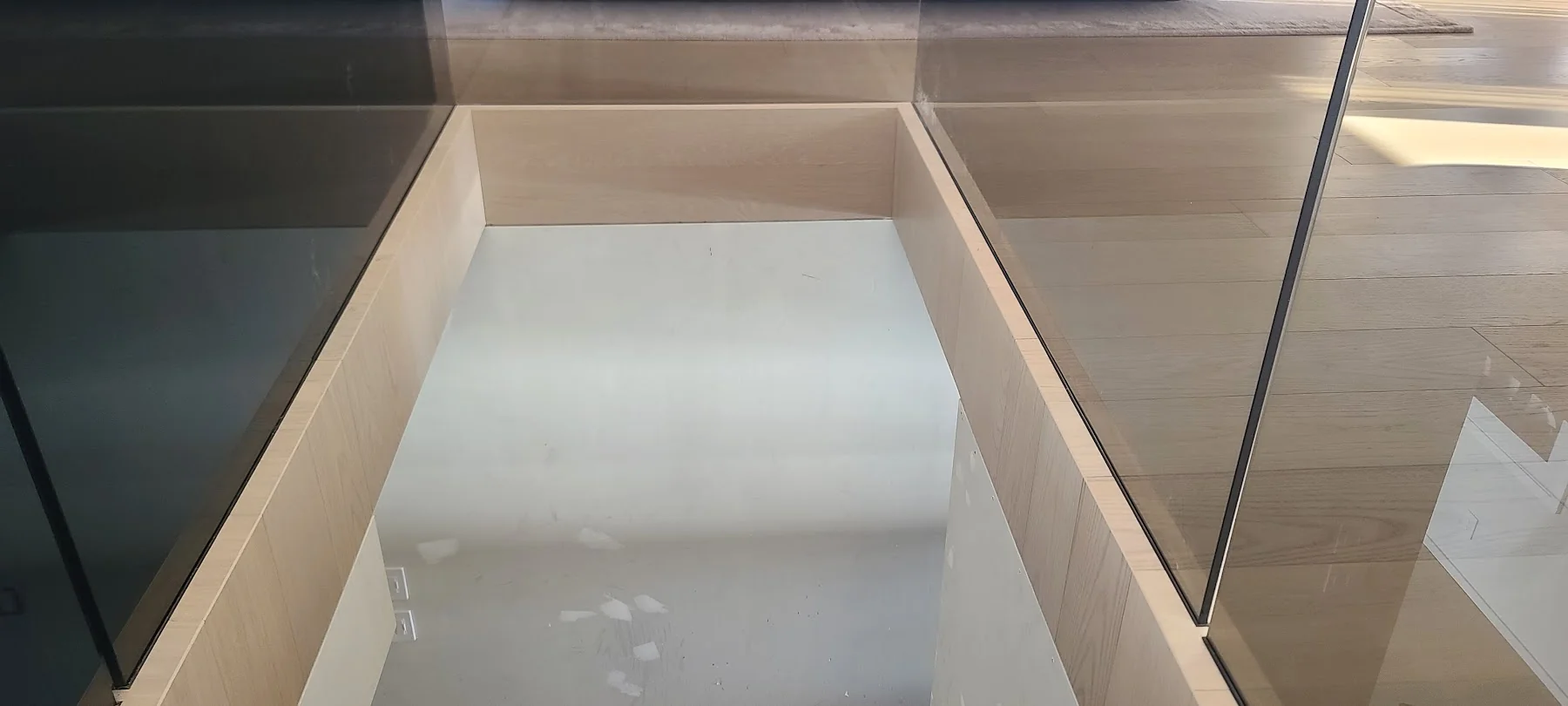 Mitred oak returns beneath glass at Horseshoe Bay during construction