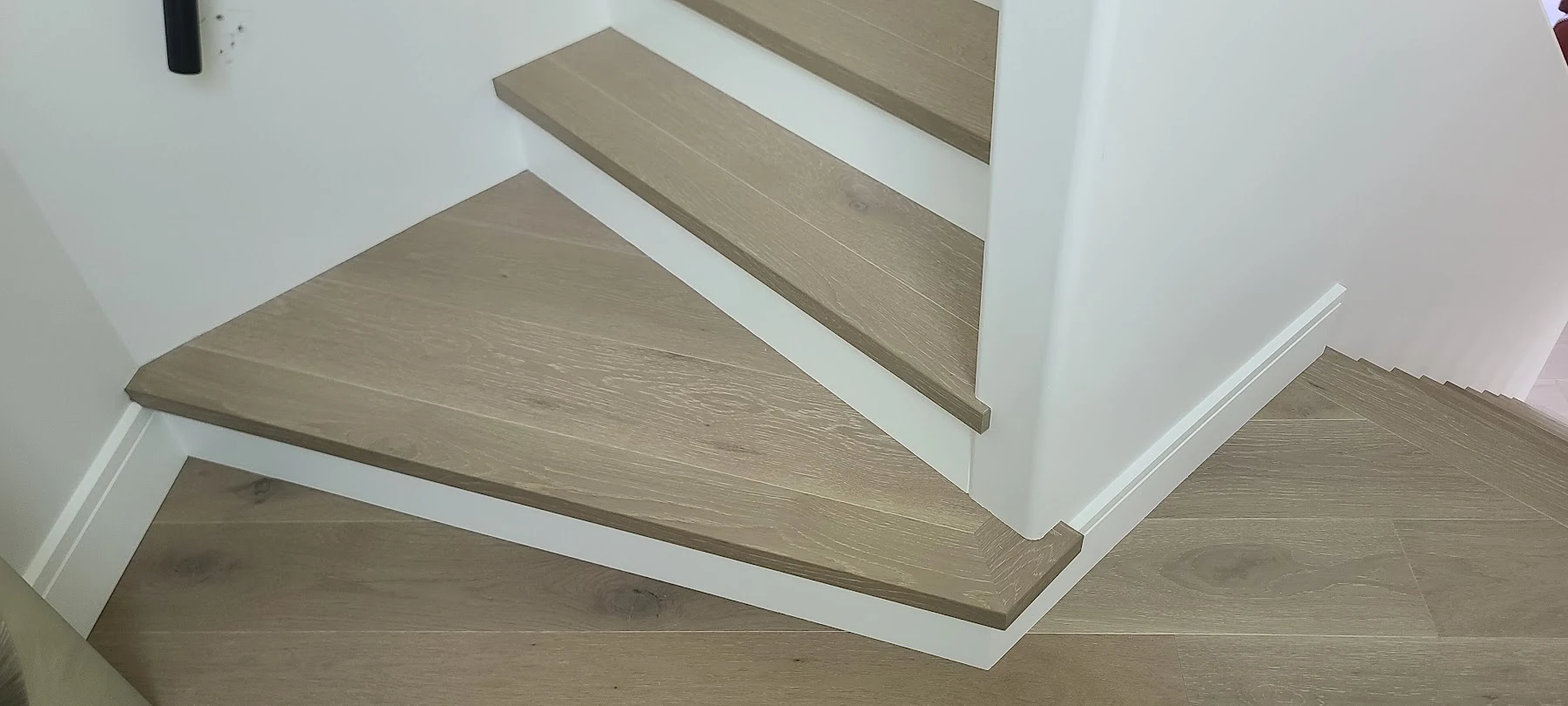 Oak wrapping around the angled stair treads.