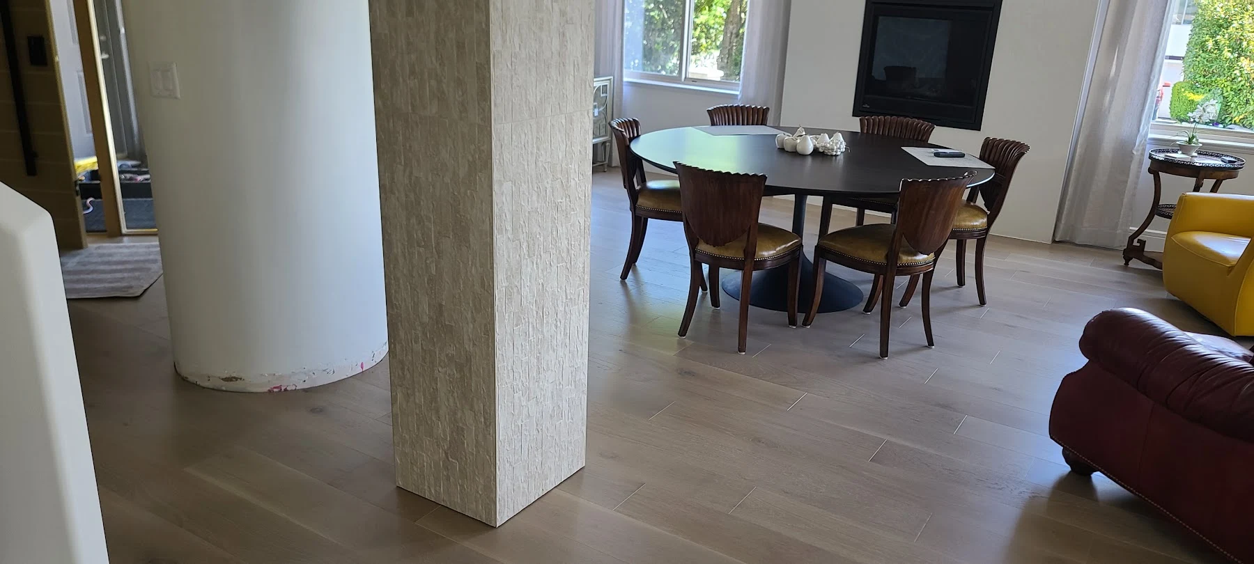 Natural oak across the furnished dining space.