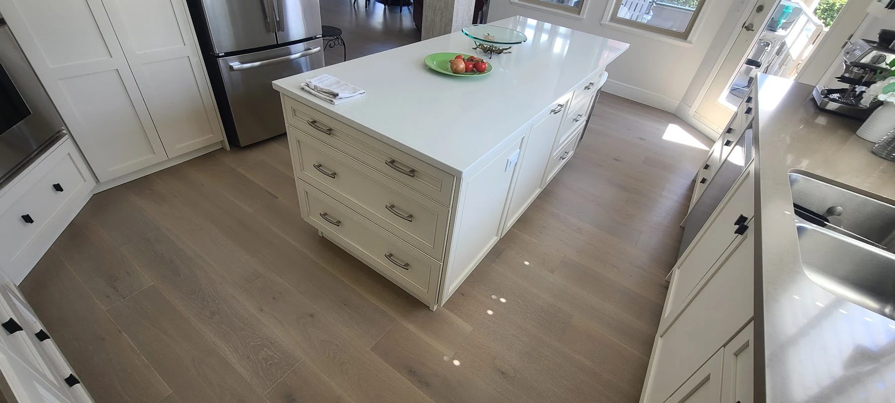 Oak flooring fitted around the kitchen island.