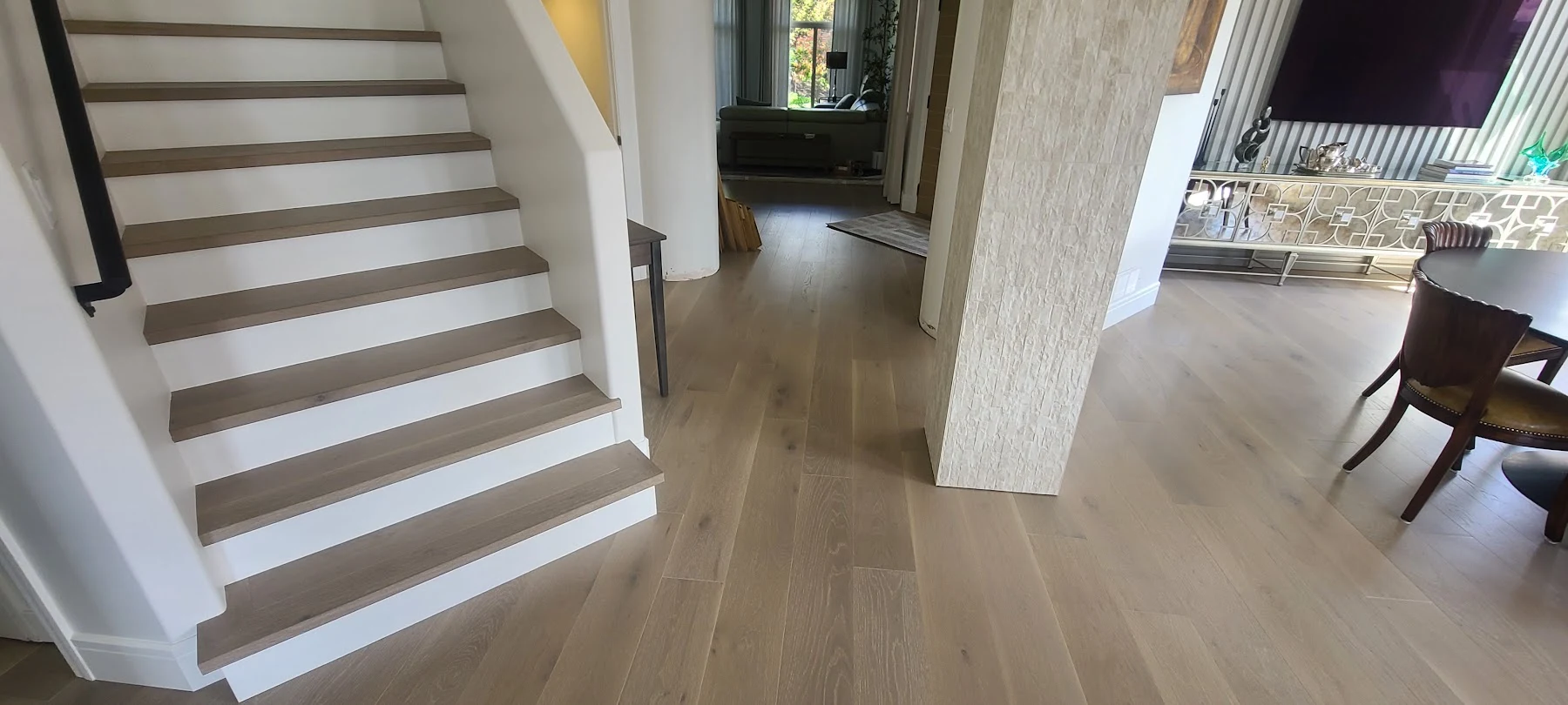 Oak floors connecting the staircase and dining room