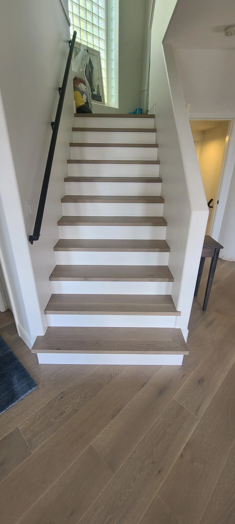 Oak treads and white risers through the full staircase.