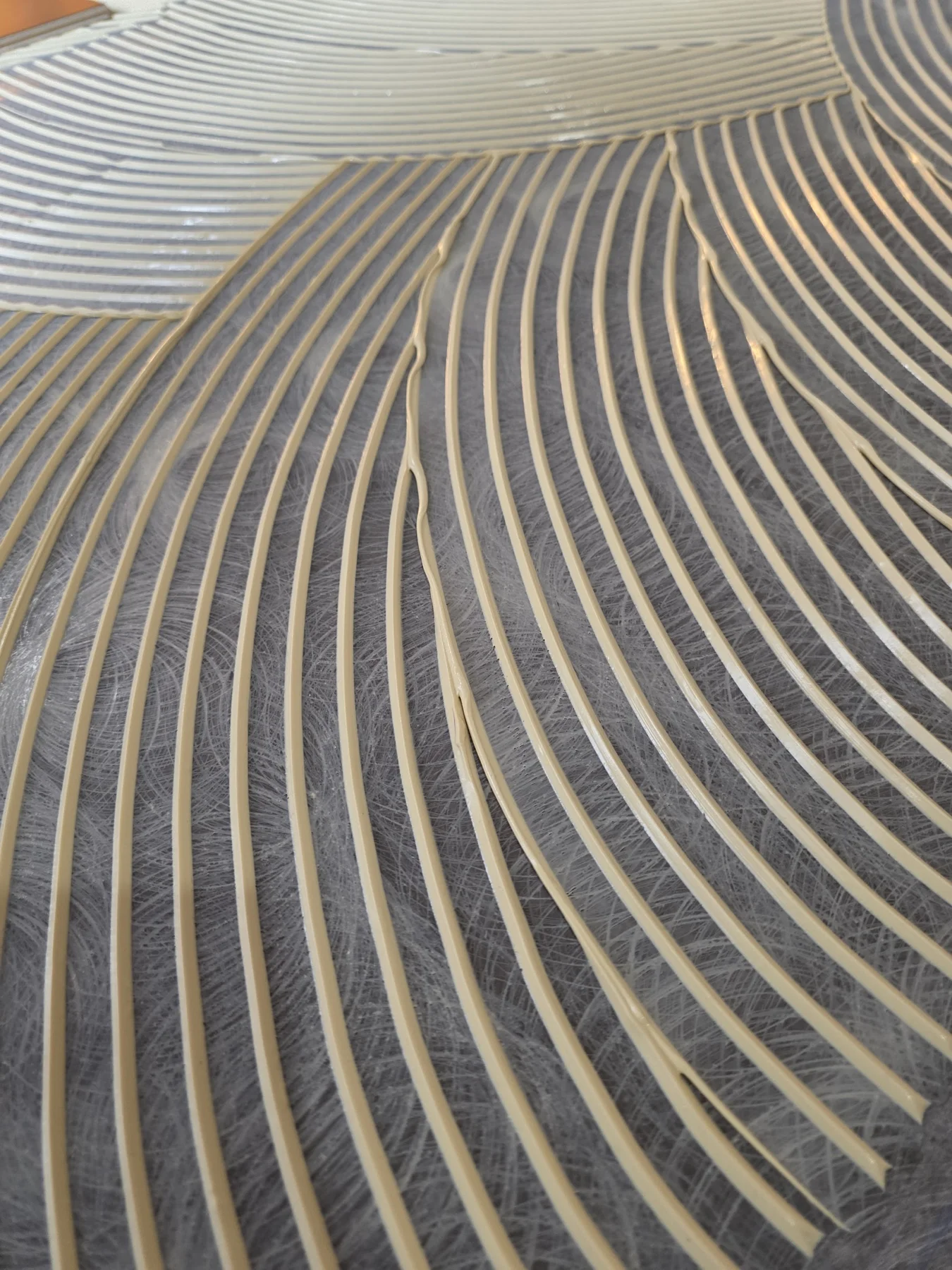 Mechanical preparation and freshly trowelled adhesive in the same view.