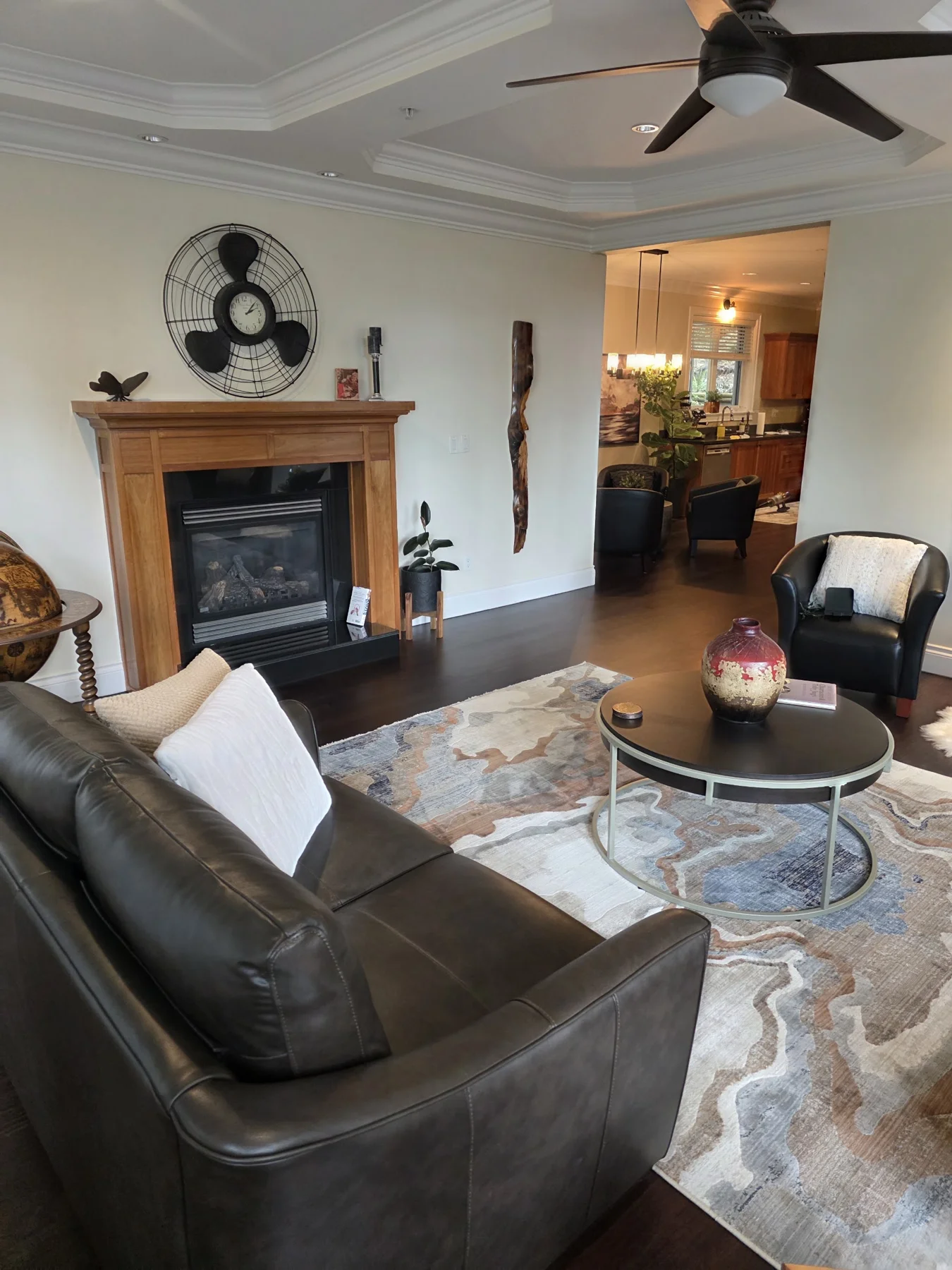 Rich hardwood tones connect the fireplace seating area and dining room.