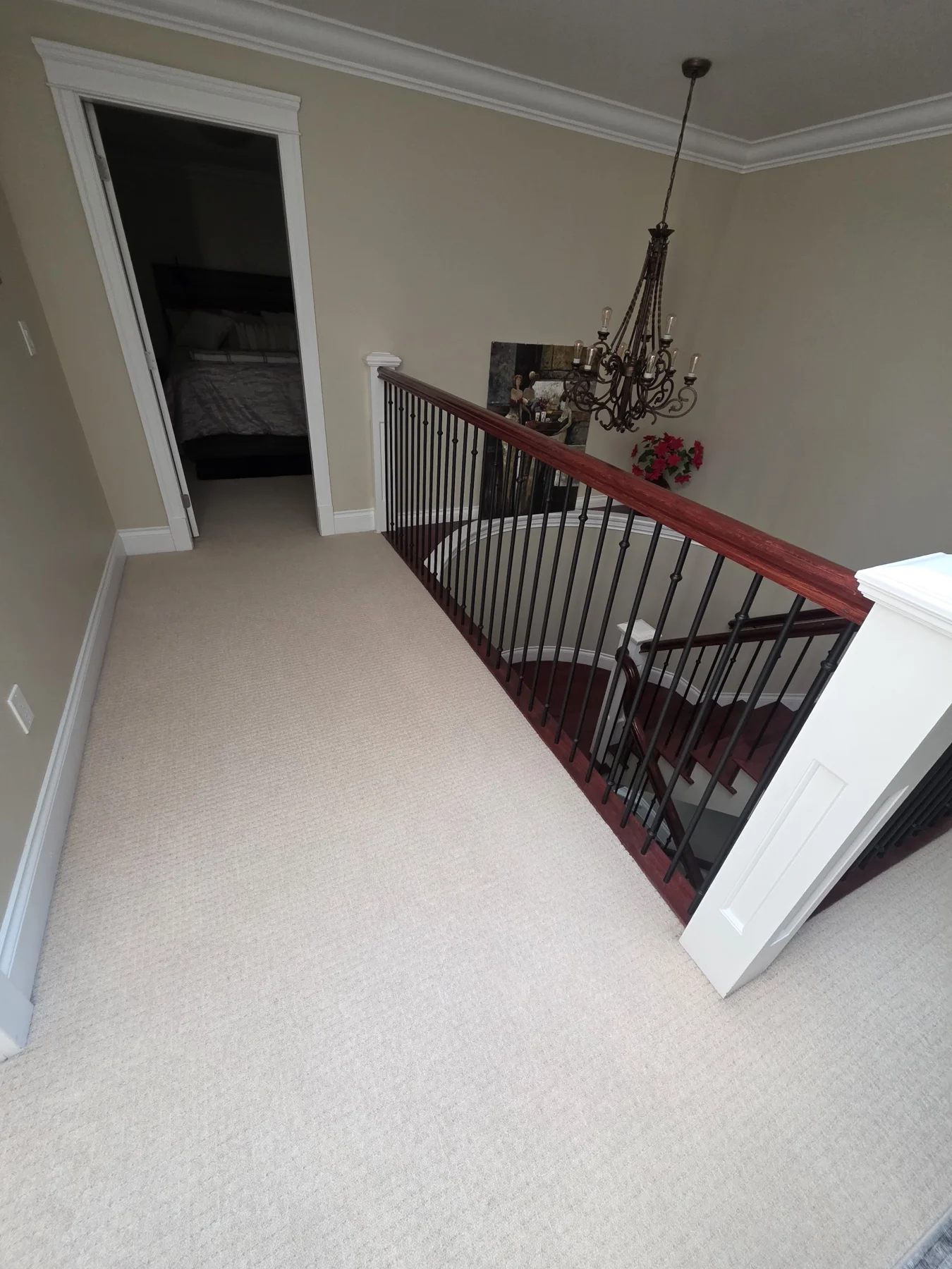 The original handrail beside the carpeted landing.